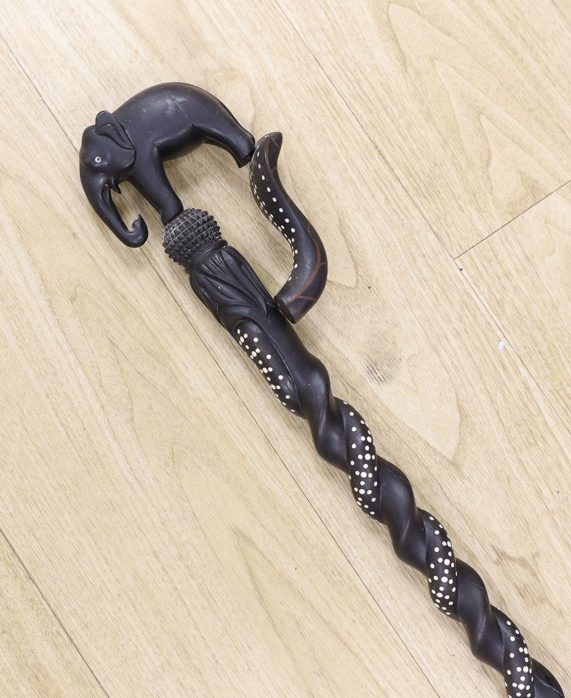 A late 19th/early 20th century Ceylonese carved ebony ‘elephant’ walking stick, 90cm